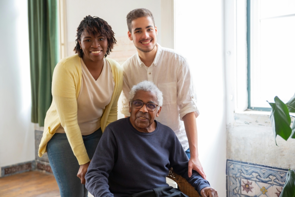 Happy multigenerational family smiling indoors, showing warmth and connection.